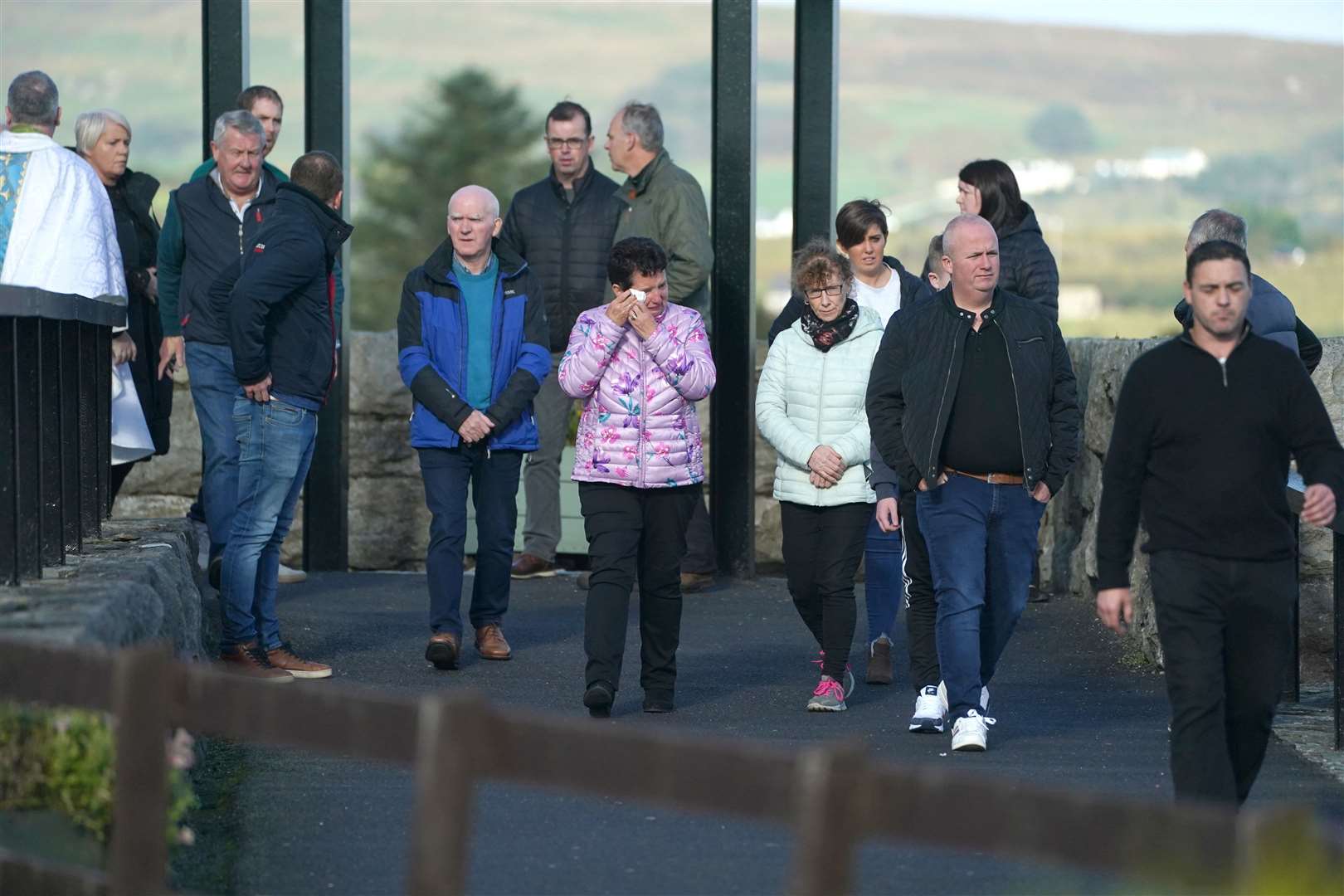 People leave St Michael’s Church Creeslough after a Mass as emergency services continue their work at the scene of an explosion (Brian Lawless/PA)