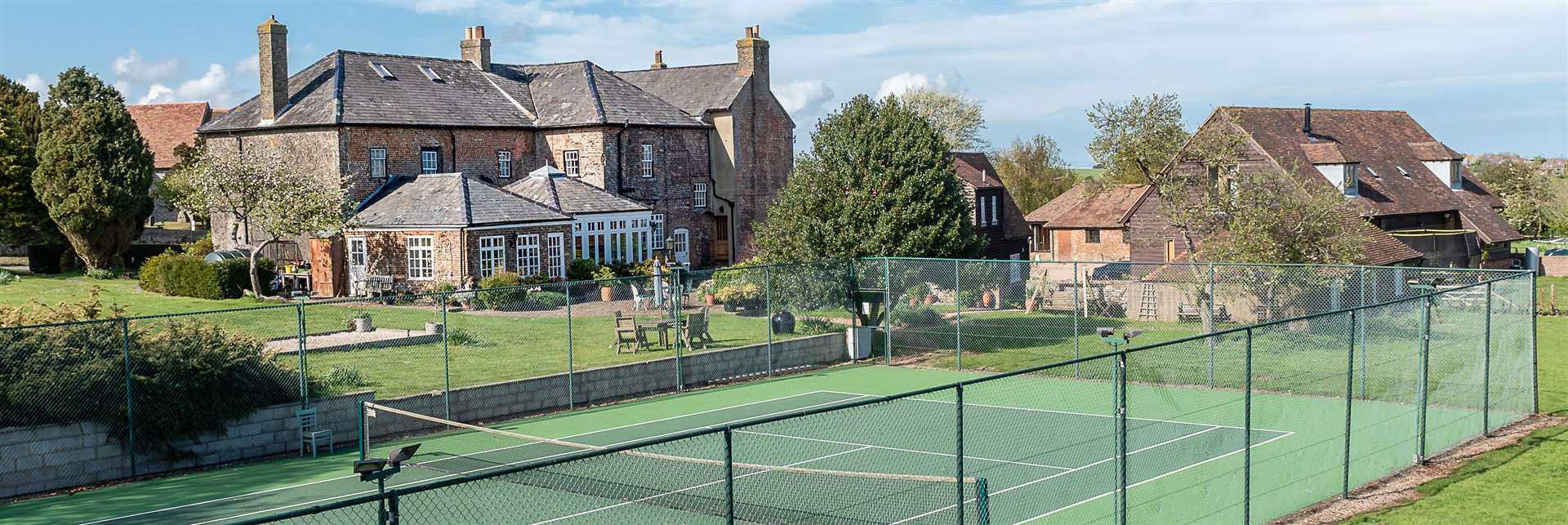 The property comes with an all-weather tennis court