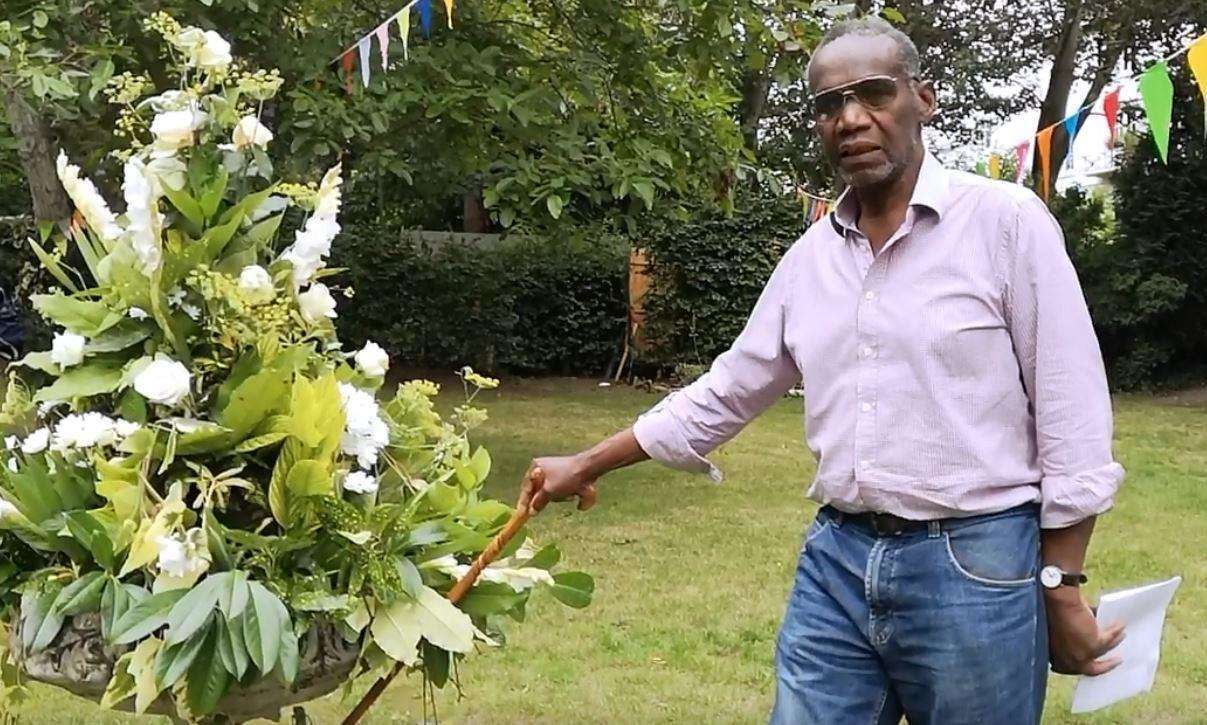 Jocelyn McCarthy of the Vale Square Residents' Group next to the floral tribute to former residents (3689386)