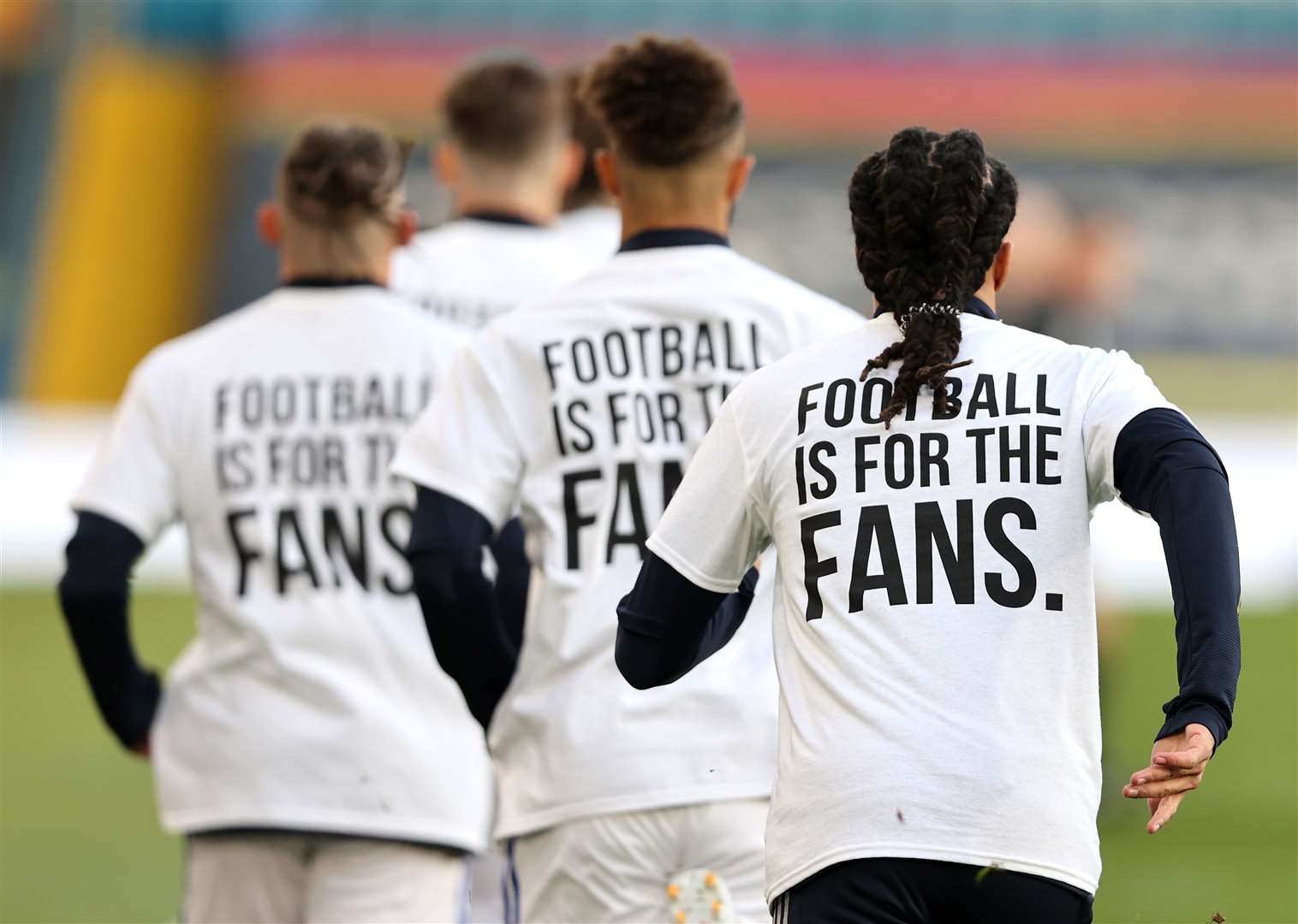 Leeds United players sporting ‘Football Is For The Fans’ shirts during the warm-up to their match against Liverpool (Clive Brunskill/PA)