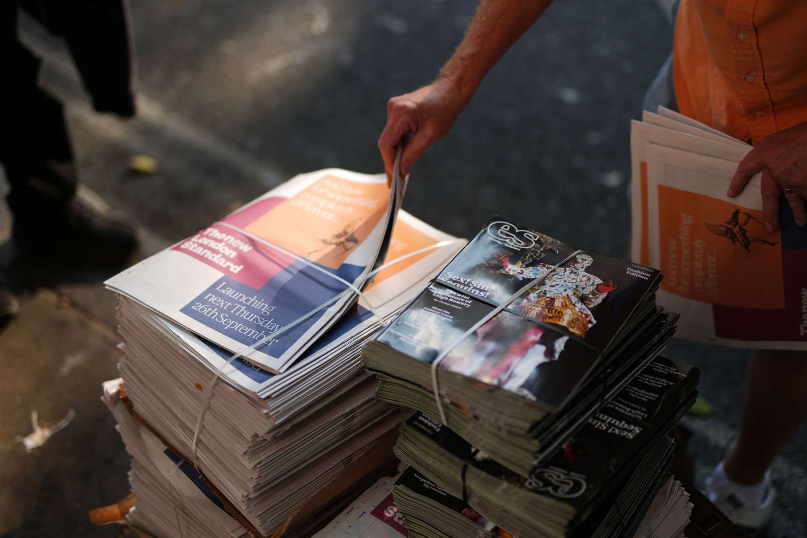 Copies of the final print of the London Evening Standard are taken by readers as the paper moves to weekly-only editions and a rebrand (Jordan Pettitt/PA)