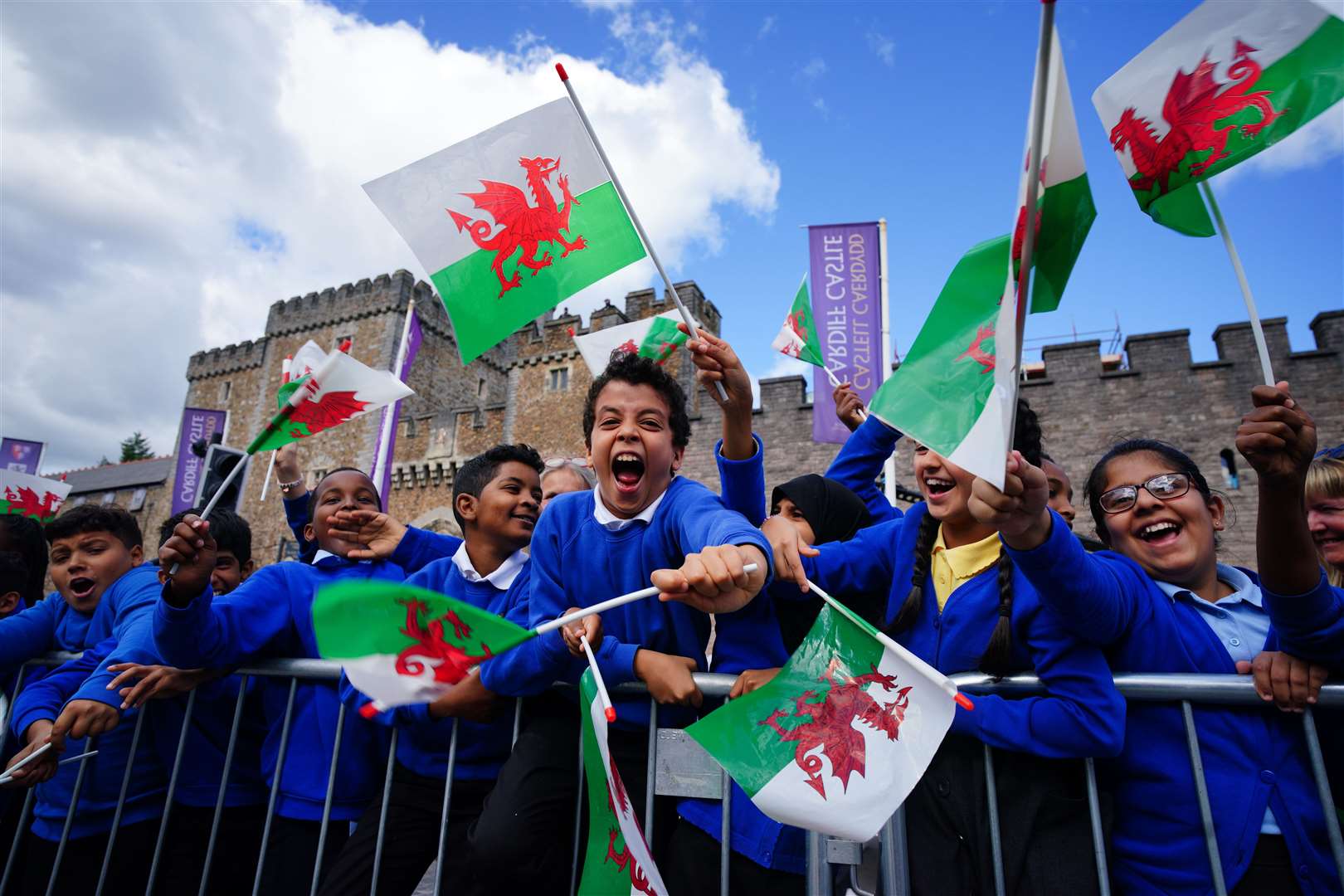 School children wait for King Charles III to arrive at Cardiff Castle in Wales (Ben Birchall/PA)