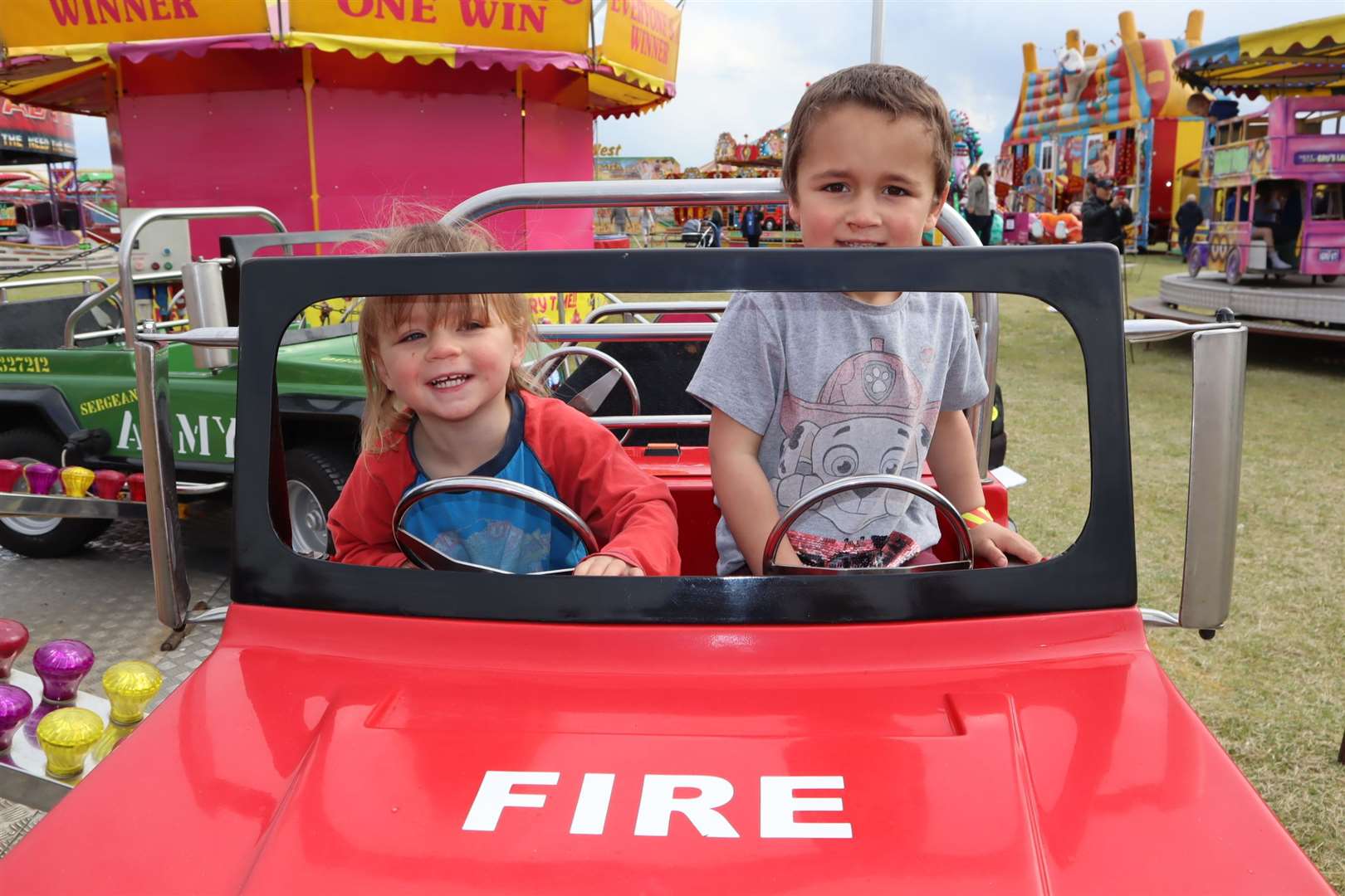 Charlotte Philcox, 2, and her brother Ralph, 4, rode the fire truck at Smith's funfair at Barton's Point, Sheerness