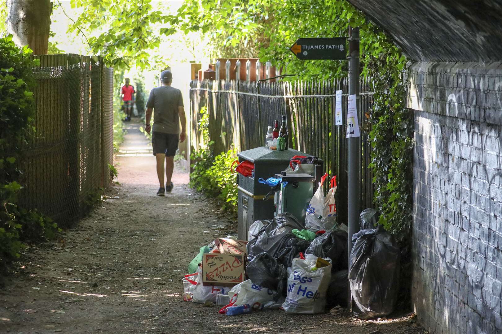 Rubbish piles up next to a bin (Steve Parsons/PA)