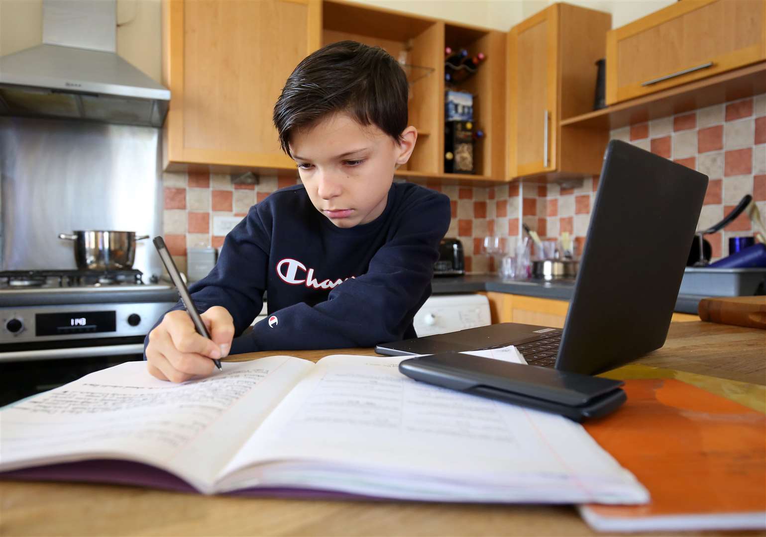 Euan Stanton, a year 7 pupil in Ashford, Kent, studies at home as many schools switch to online learning following their closure due to the increasing spread of Covid-19 (Gareth Fuller/PA Wire)