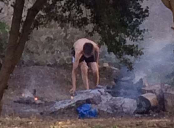 Boy spotted stoking a bonfire in a plot of land set to be a baby memorial garden