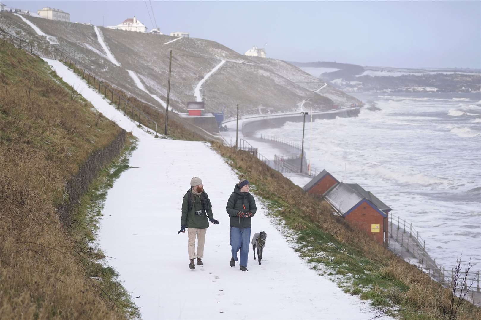 Snowy conditions on Whitby seafront in Yorkshire (Danny Lawson/PA)