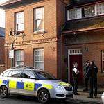 Police outside the flat in Victoria Road, Canterbury, where a woman's body was found