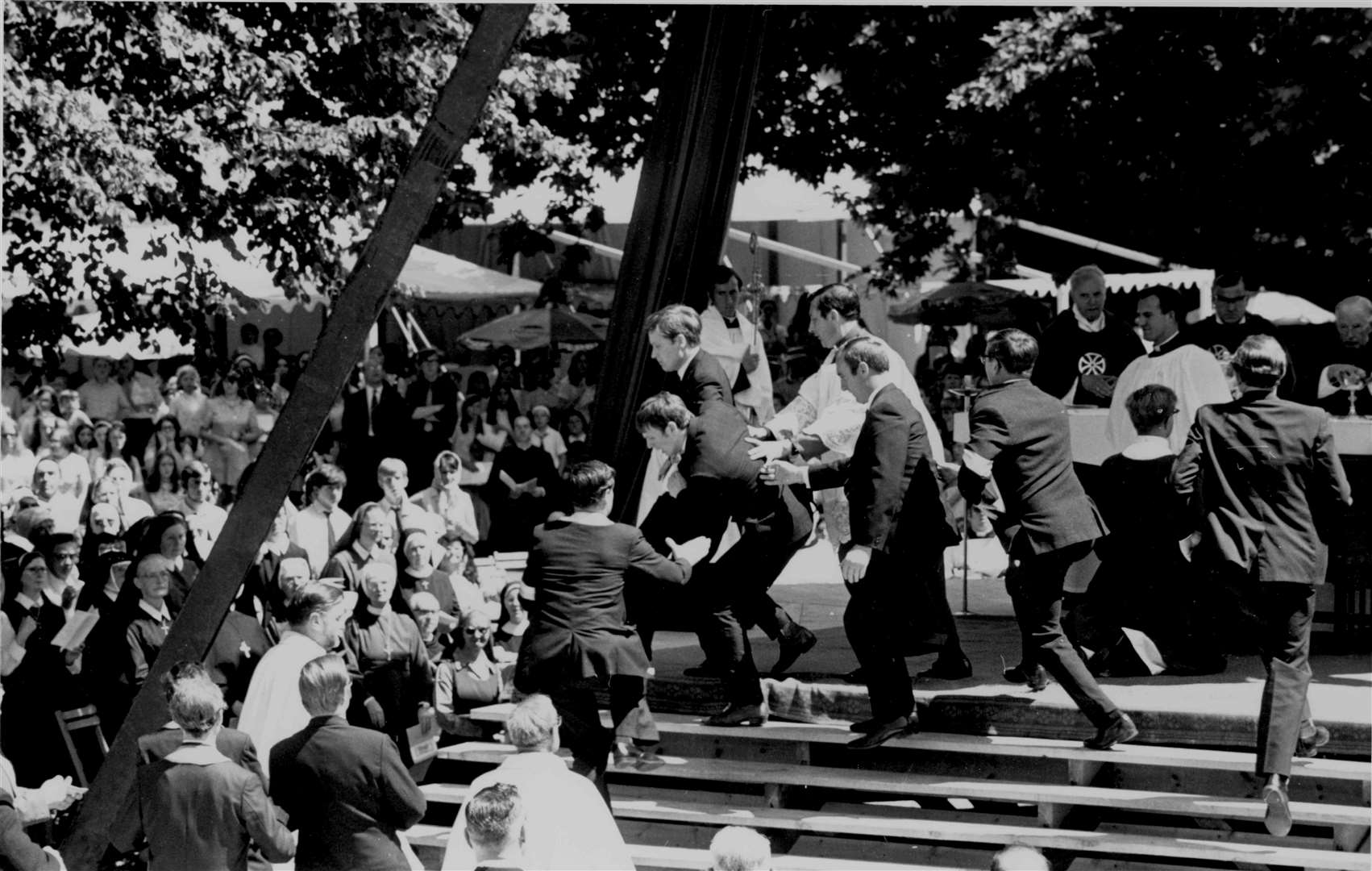 Police grapple with two militant Protestants who rushed the altar during a Roman Catholic mass at Canterbury Cathedral