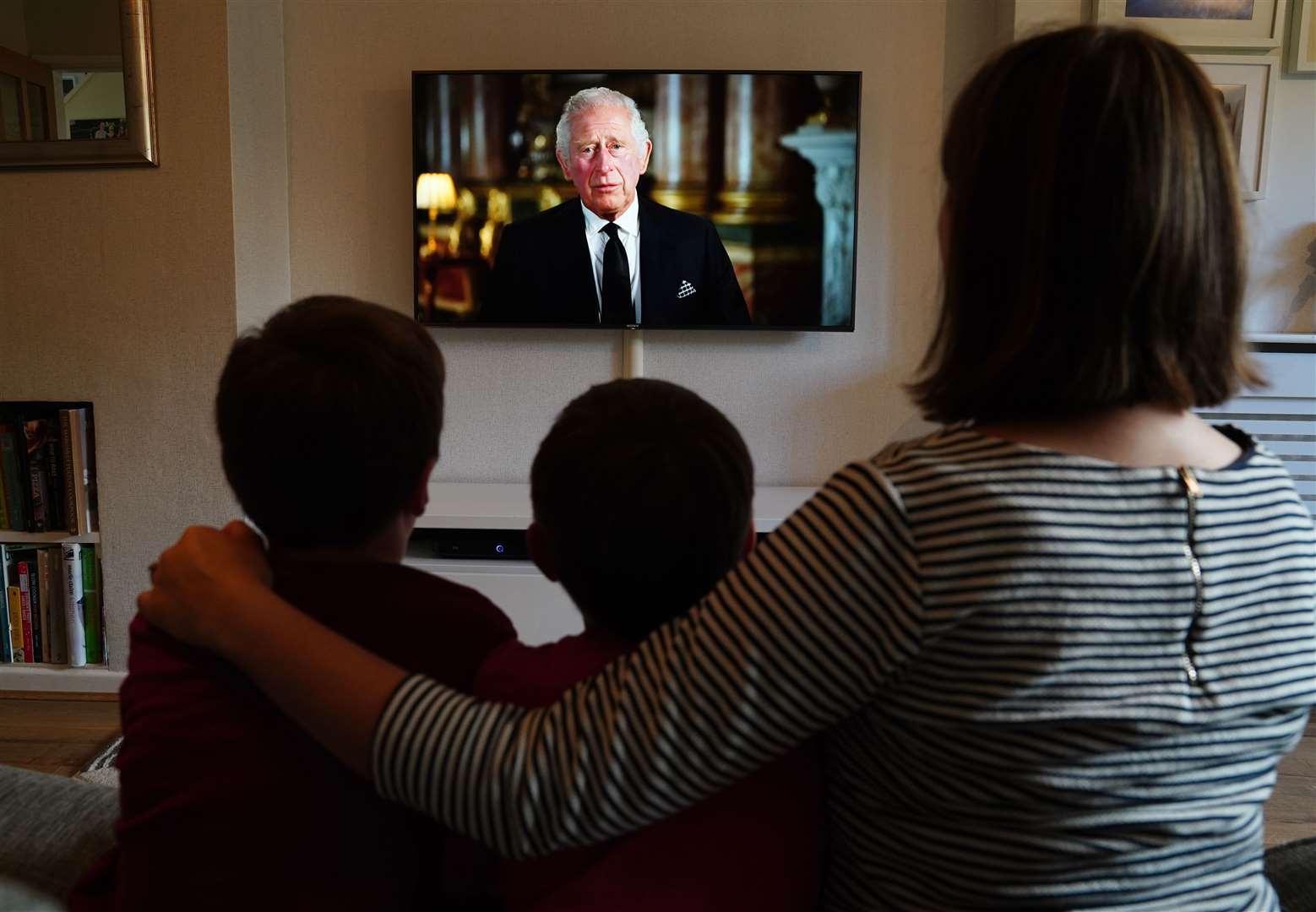 People watching a broadcast of Charles’s first address to the nation as King (Martin Rickett/PA)