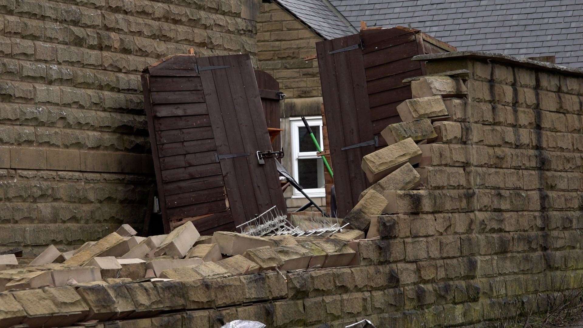 A damaged wall and gate in Stalybridge (Richard McCarthy/PA)