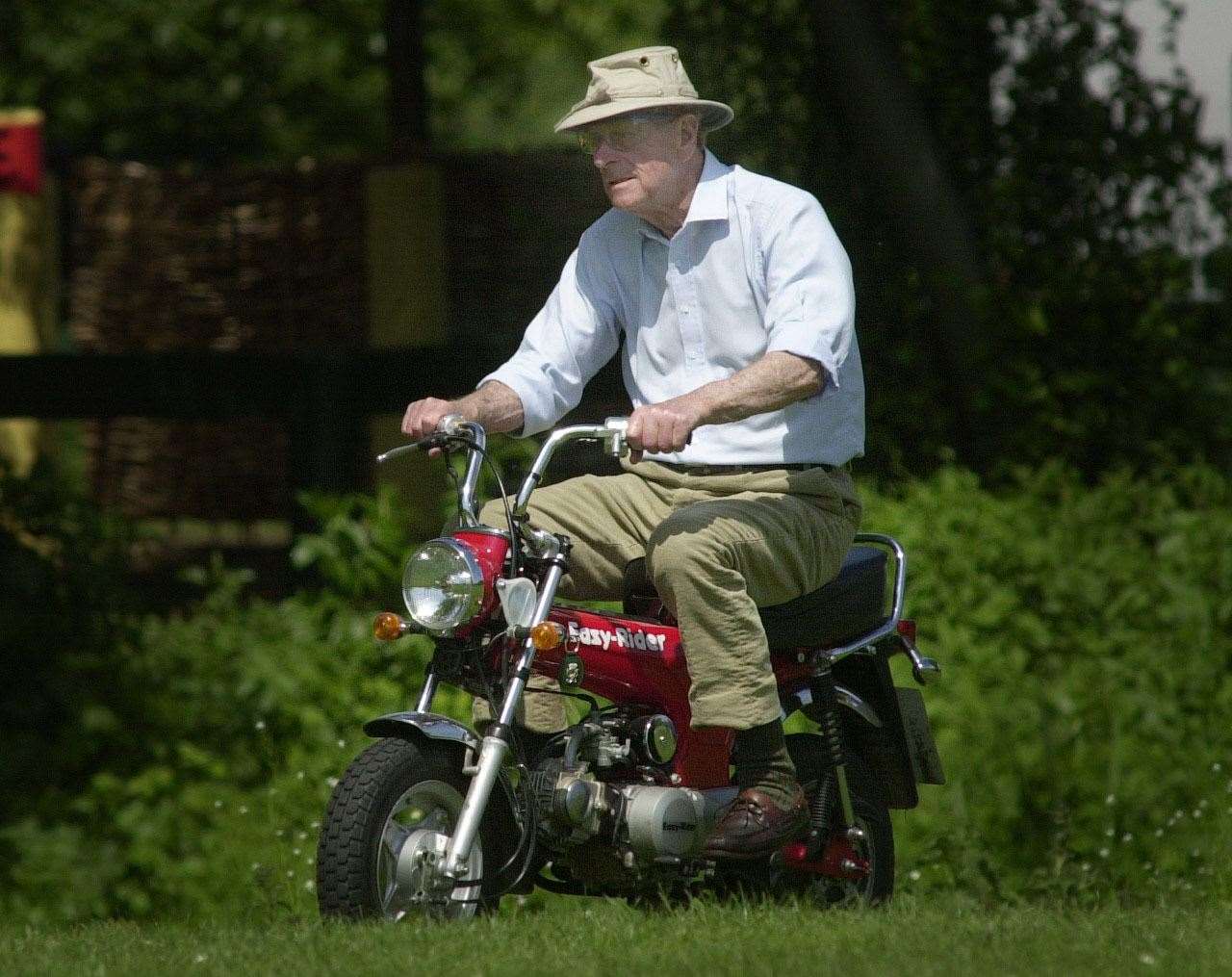 A man with a keen eye for active pursuits, Philip rode a mini motorbike around the Royal Windsor Horse Show in 2002 (Stefan Rousseau/PA)