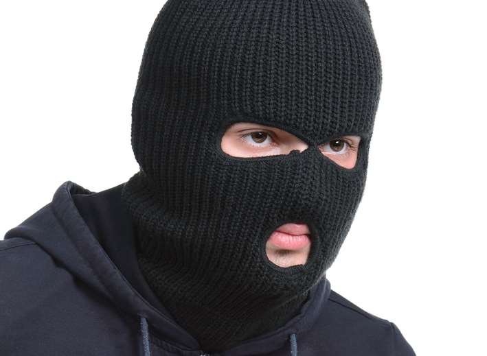 The raiders were wearing balaclavas. Stock image