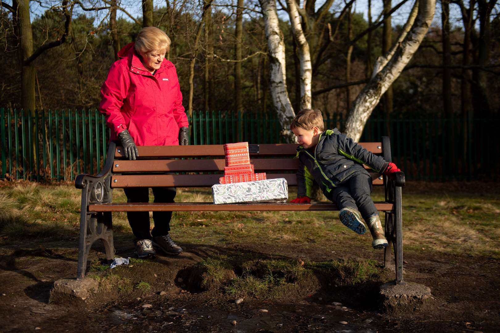 Four-year-old Archie receives gifts, socially distanced, from his grandparents in Sutton Park, in Sutton Coldfield (Jacob King/PA)