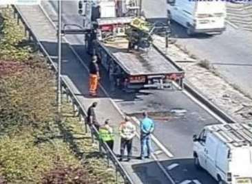 A piece of metal fell from the flatbed lorry causing damage to the road