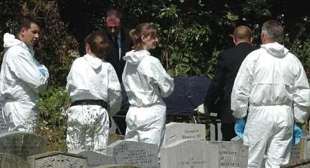 GRIM FIND: Undertakers and police at the cemetery. Picture: GRANT FALVEY