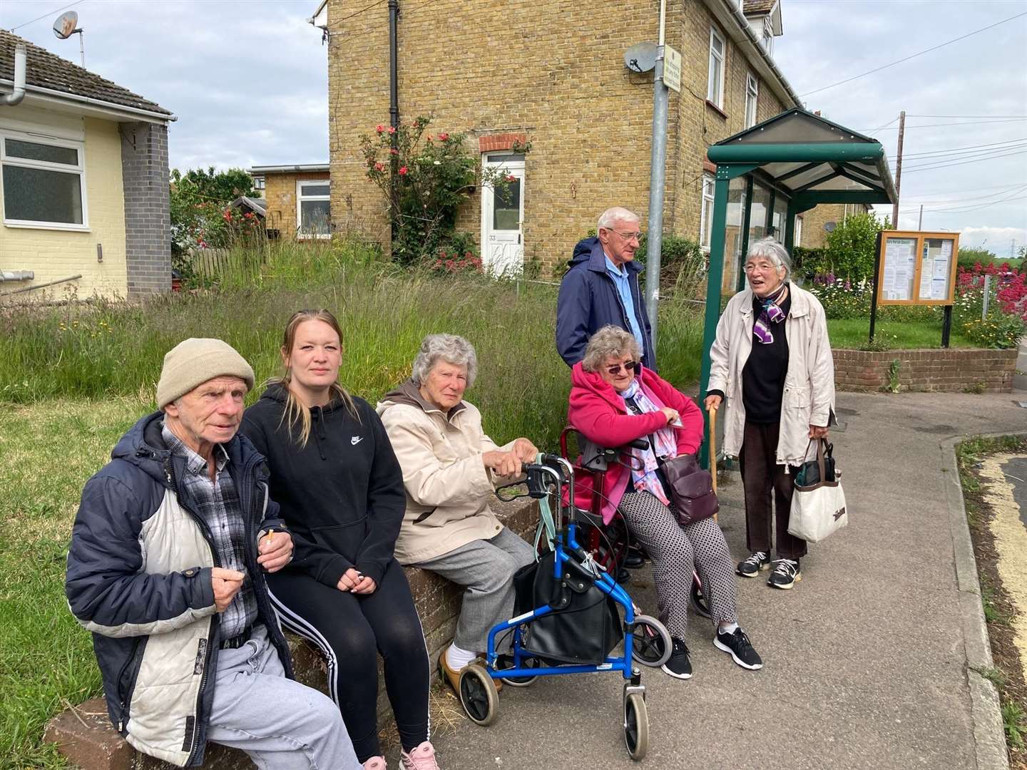 Passengers wait to board the final bus to stop in Oare