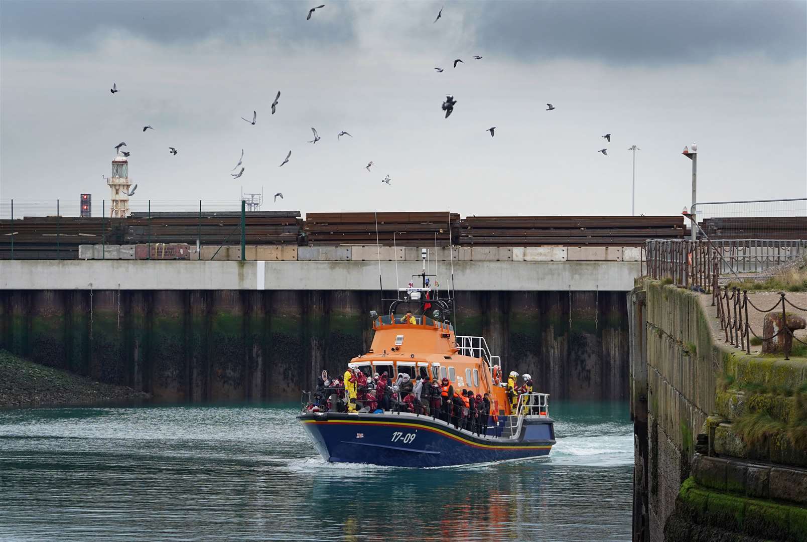 A group of people thought to be migrants are brought in to Dover, Kent, on board a lifeboat (Gareth Fuller/PA)