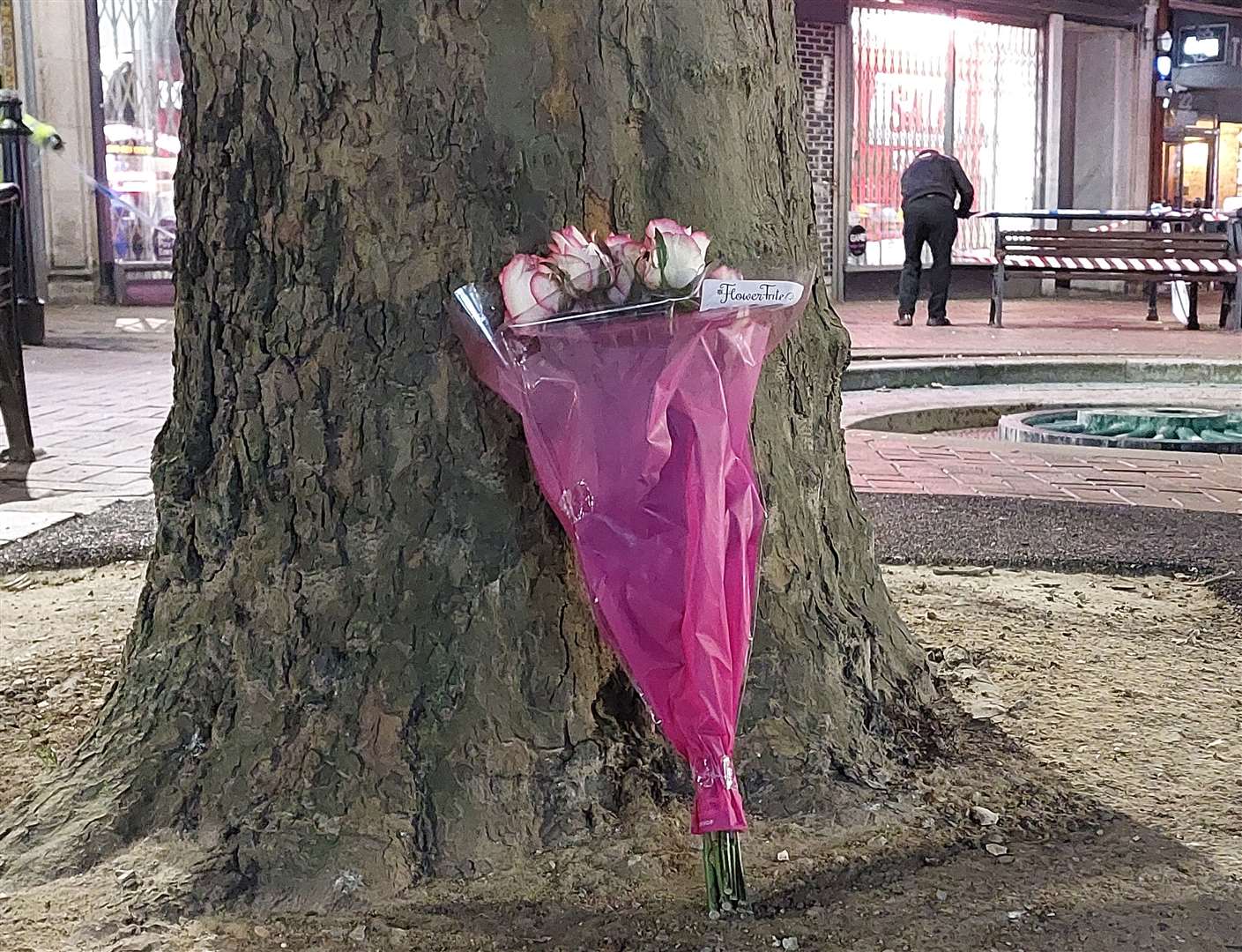 Flowers were left resting against a tree following the death