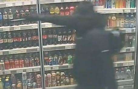 Frankie Whittington holding a meat cleaver up to the newsagents' worker in Gravesend. Picture: Kent Police