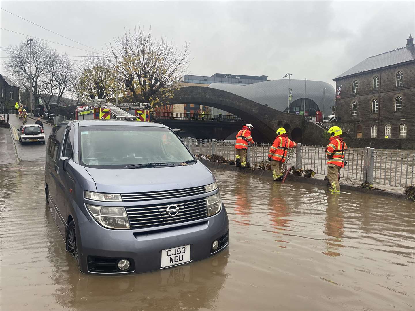 Firefighters pumping water from Sion Street by the River Taff, in Pontypridd (George Thompson/PA)