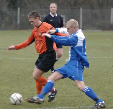 Referee Andy Carter watches on as Lordswood, orange, tussle with Erith & Belvedere on Saturday