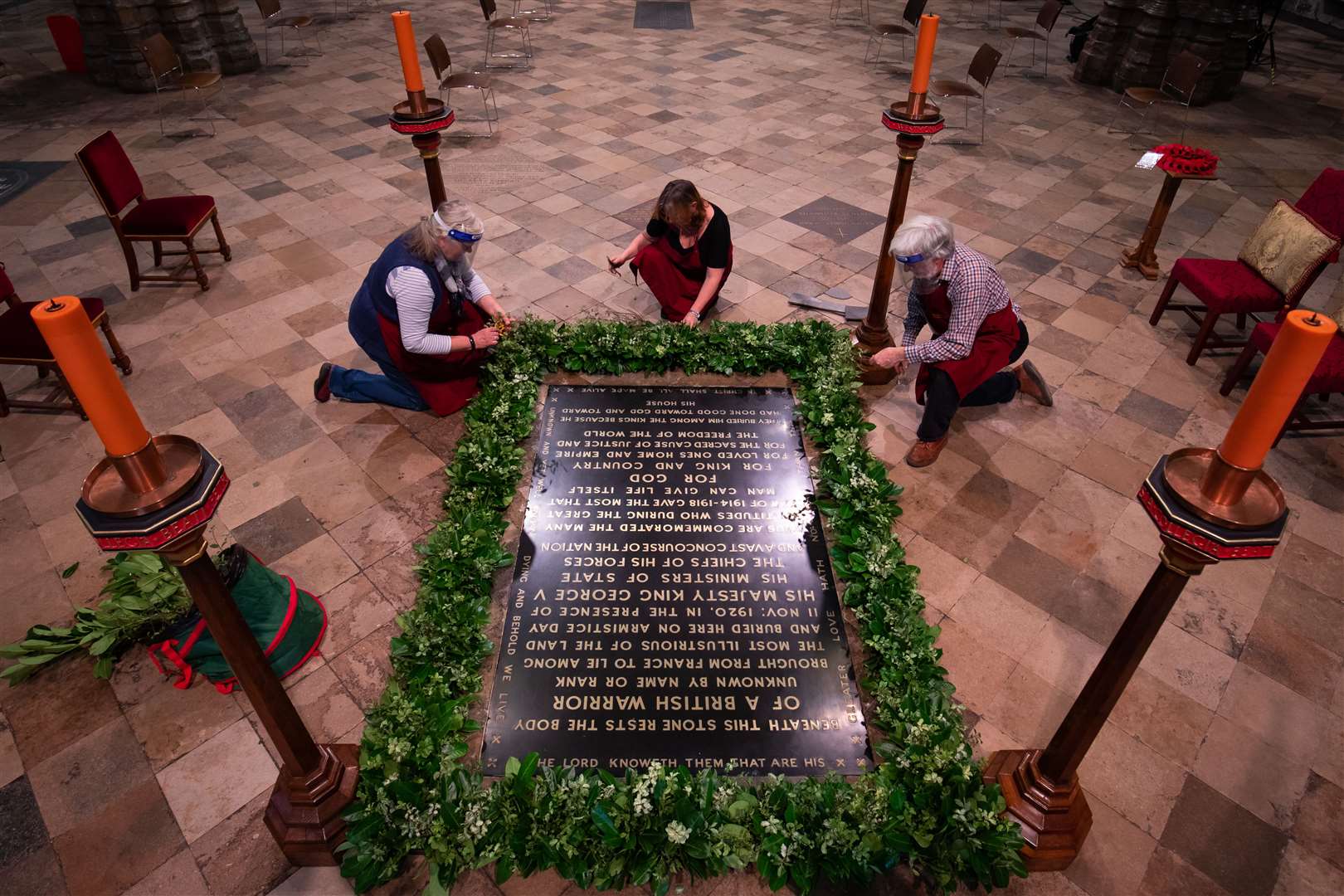 Women from the National Association of Flower Arrangers arrange laurel on the grave ahead of Wednesday’s service (Aaron Chown/PA)