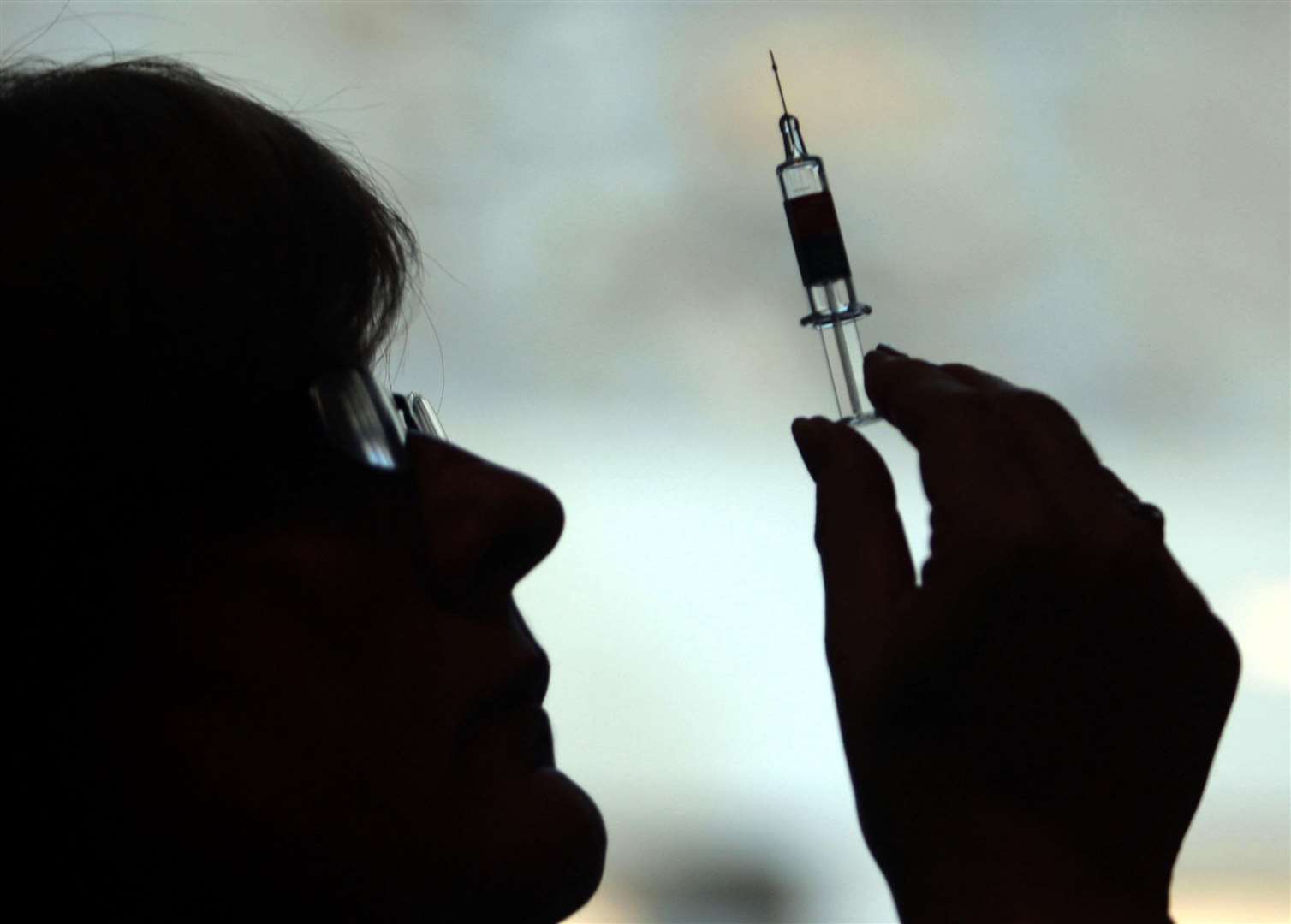 Nurse preparing to administer the winter flu jab. Stock photo