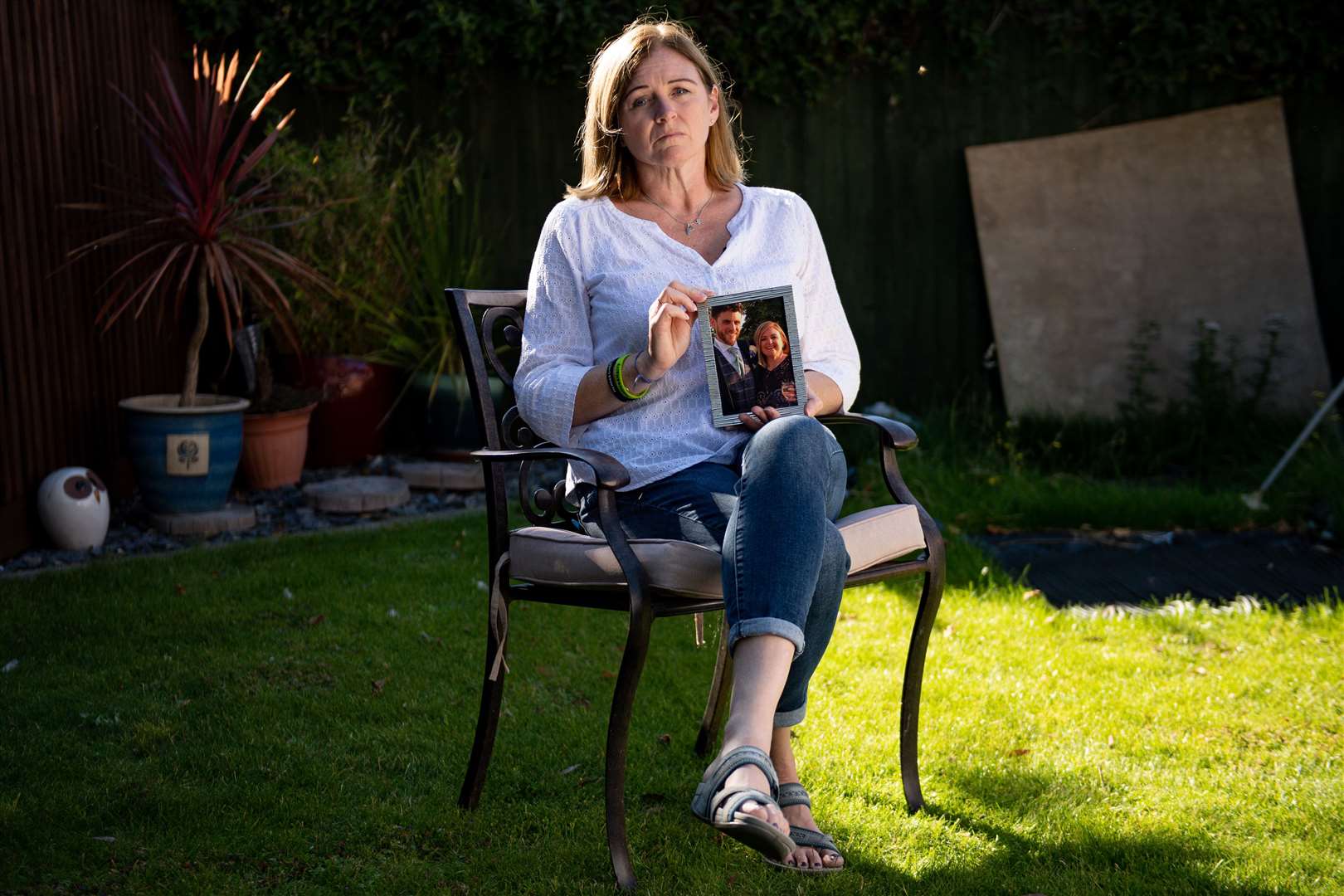 Debbie Adlam, holding a photograph of her son Pc Andrew Harper, at her home in Oxfordshire. It was announced earlier this week that the three teenagers jailed for killing the police officer will have their sentences reviewed after claims they are too lenient (Jacob King/PA)