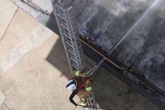 A fire fighter using cold cutting equipment. Stock image.