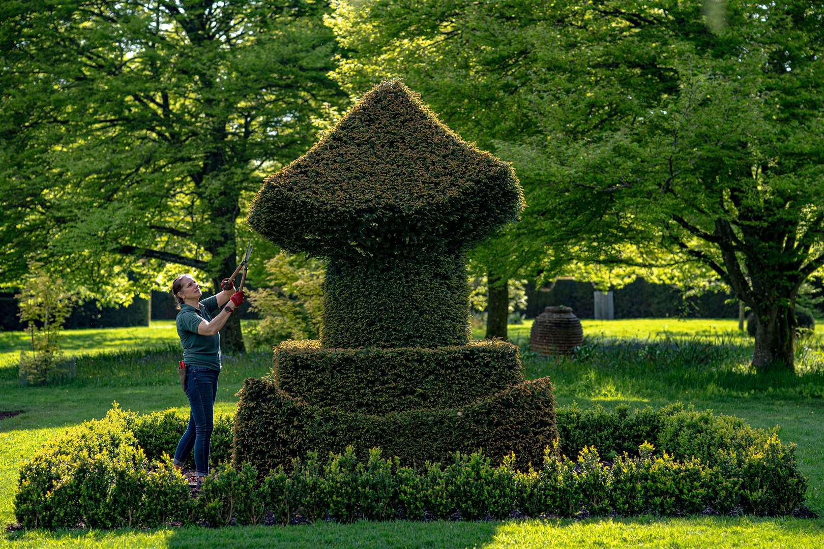 A gardener attends to a topiary bush at the King and Queen’s private residence in the gardens of Highgrove (Ben Birchall/PA)