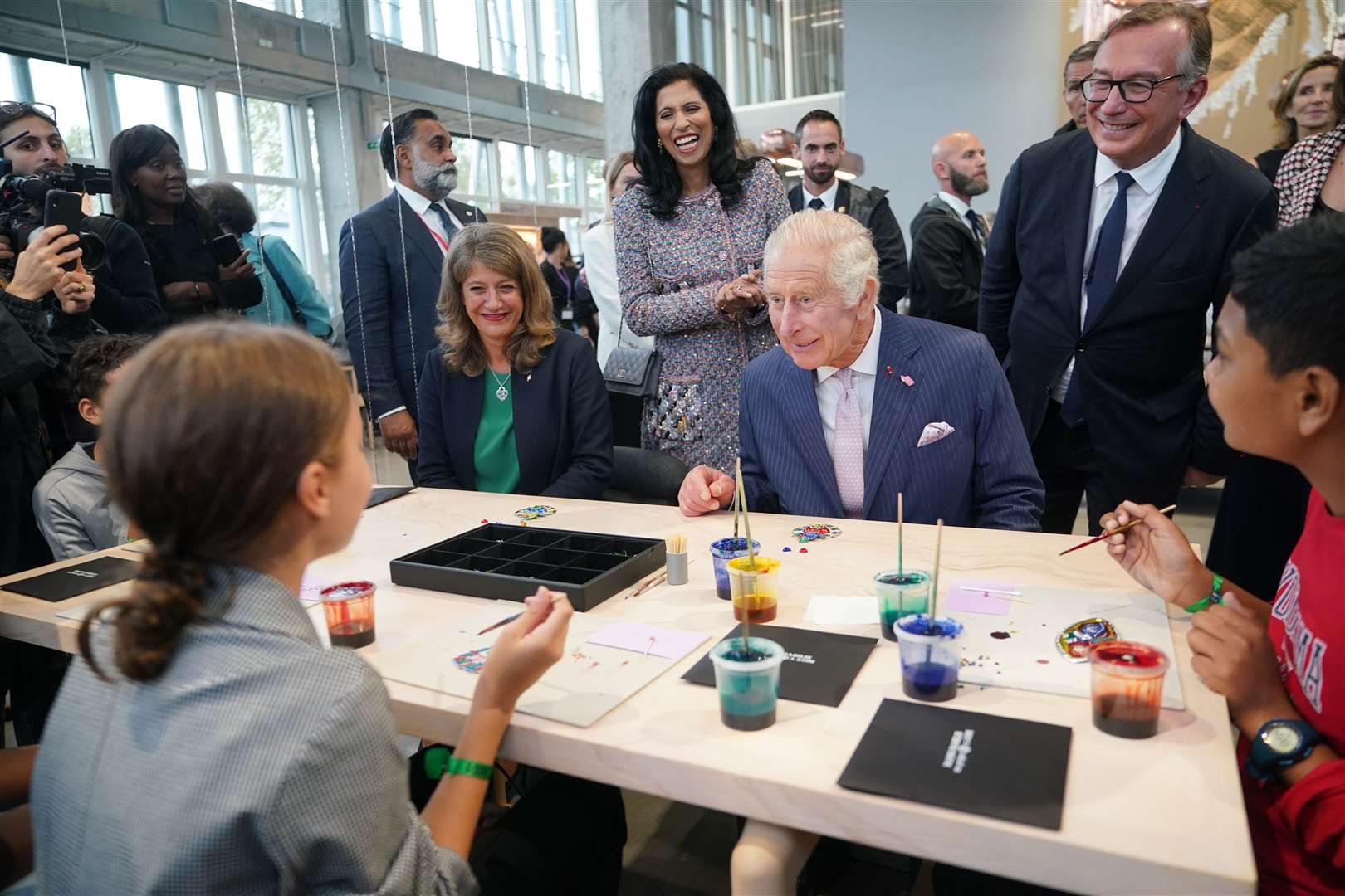 The King took part in arts and crafts with the Mayor of Aubervilliers, Karine Franclet (left), and students (Yui Mok/PA)