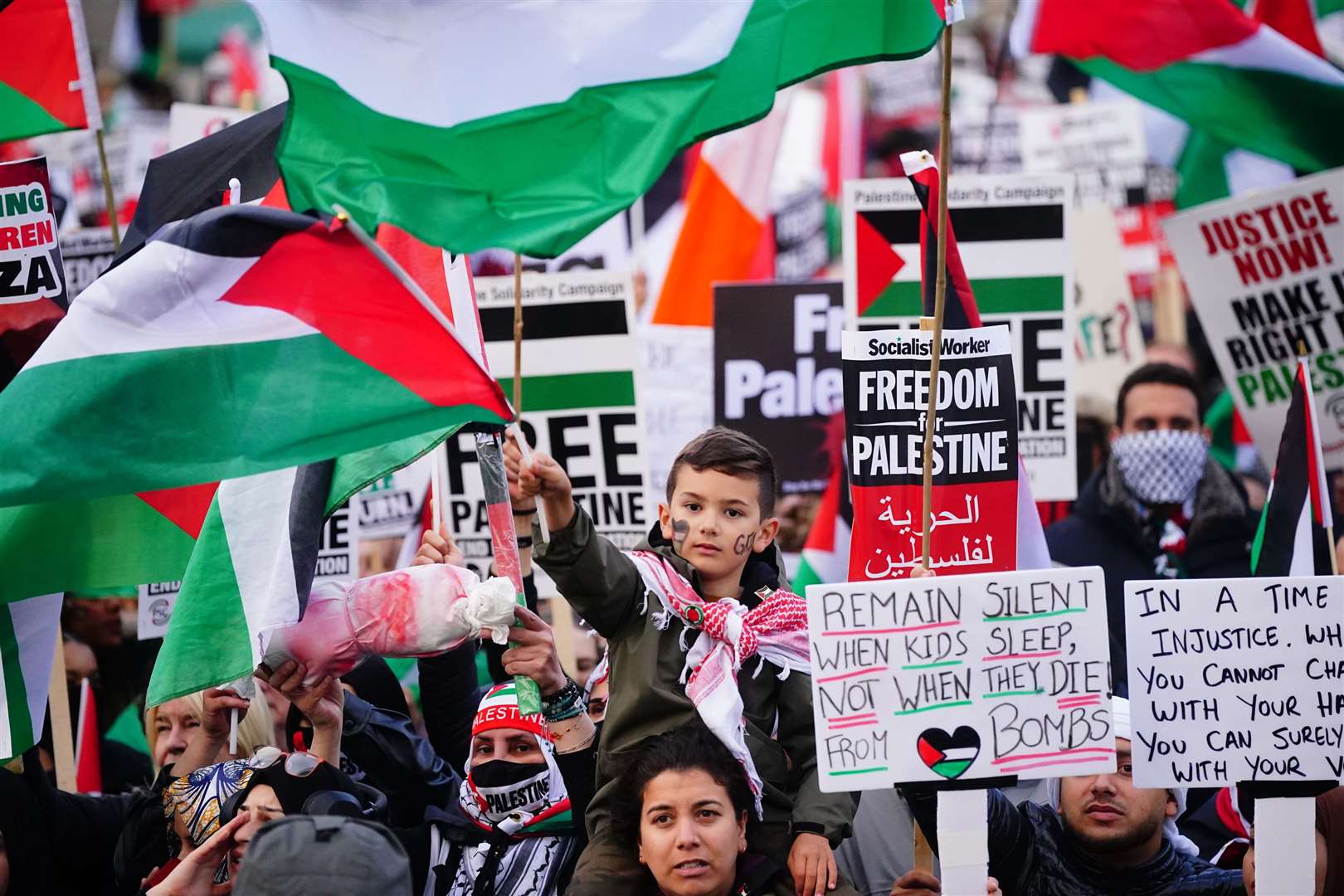 People at a rally in Trafalgar Square, London, during Stop the War coalition’s call for a Palestine ceasefire (Victoria Jones/PA)