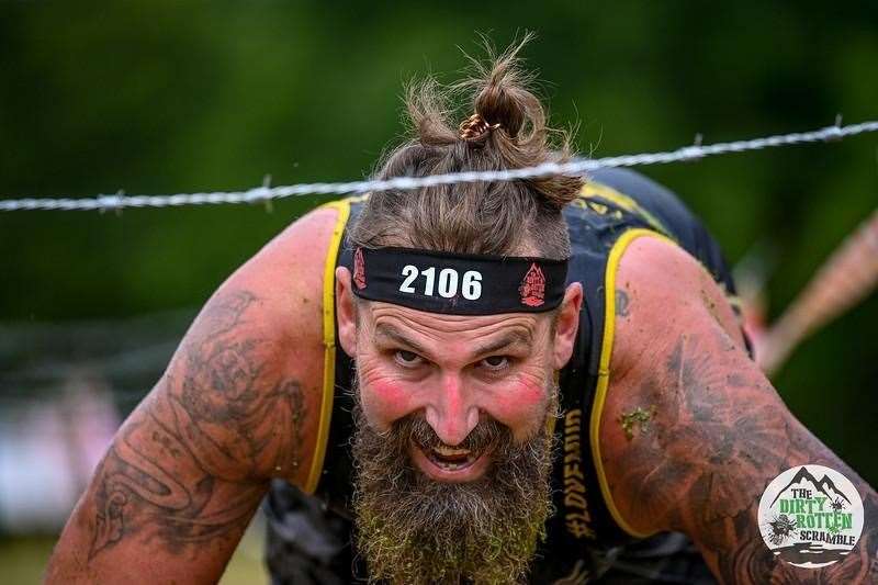 Runner going under the barbed wire crawl