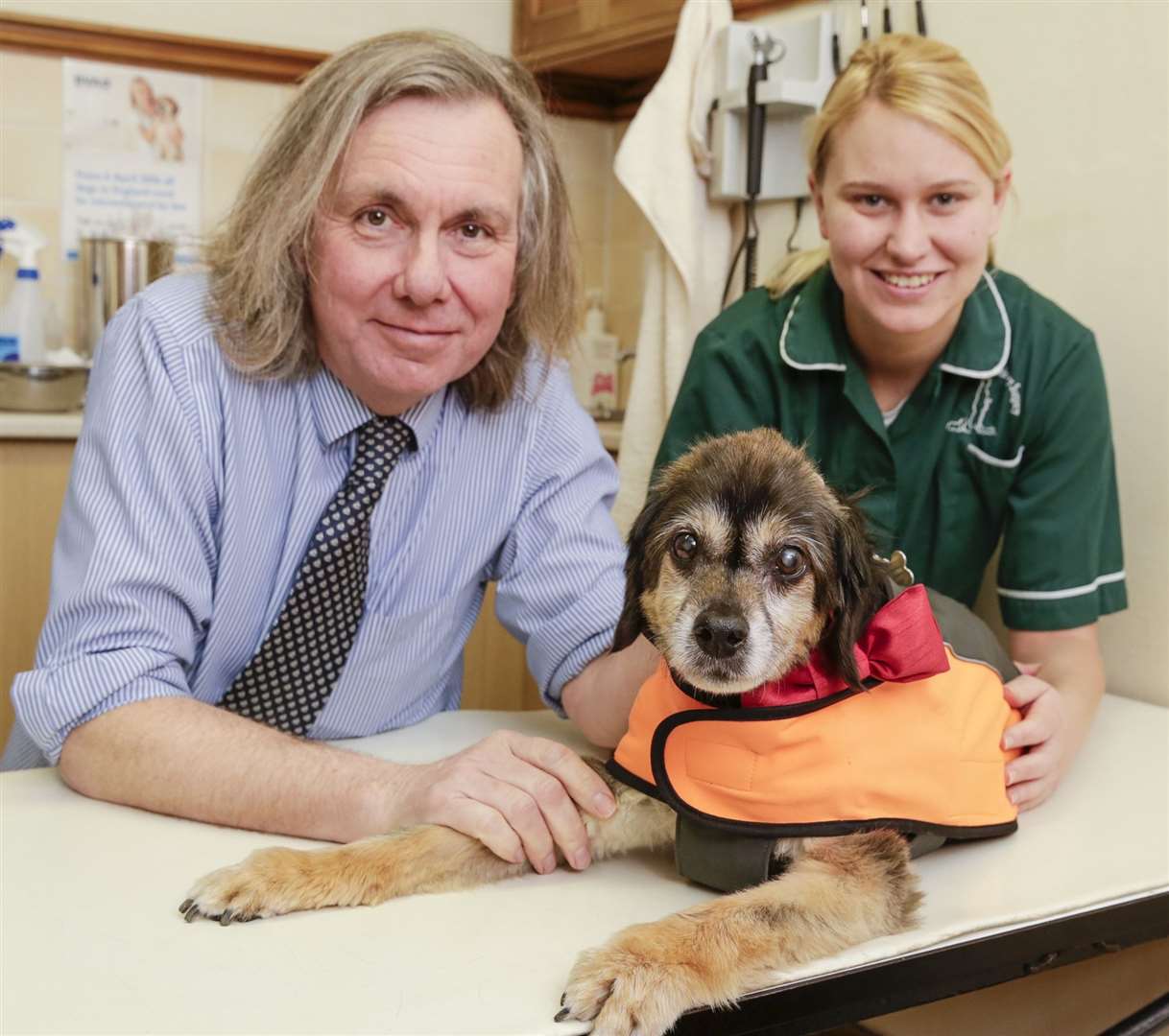 Jeremy Stattersfield with staff member Laura Wilson and Ozzie, a dog who was named the surgery's pet of the year in 2017