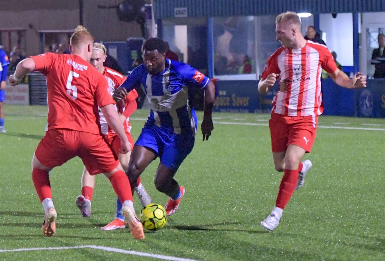 Mo Kamara drives forward for Herne Bay as he attempts to get past Danny Howick in their 2-0 Isthmian South East win over Steyning Town Community on Tuesday. Picture: Stuart Watson