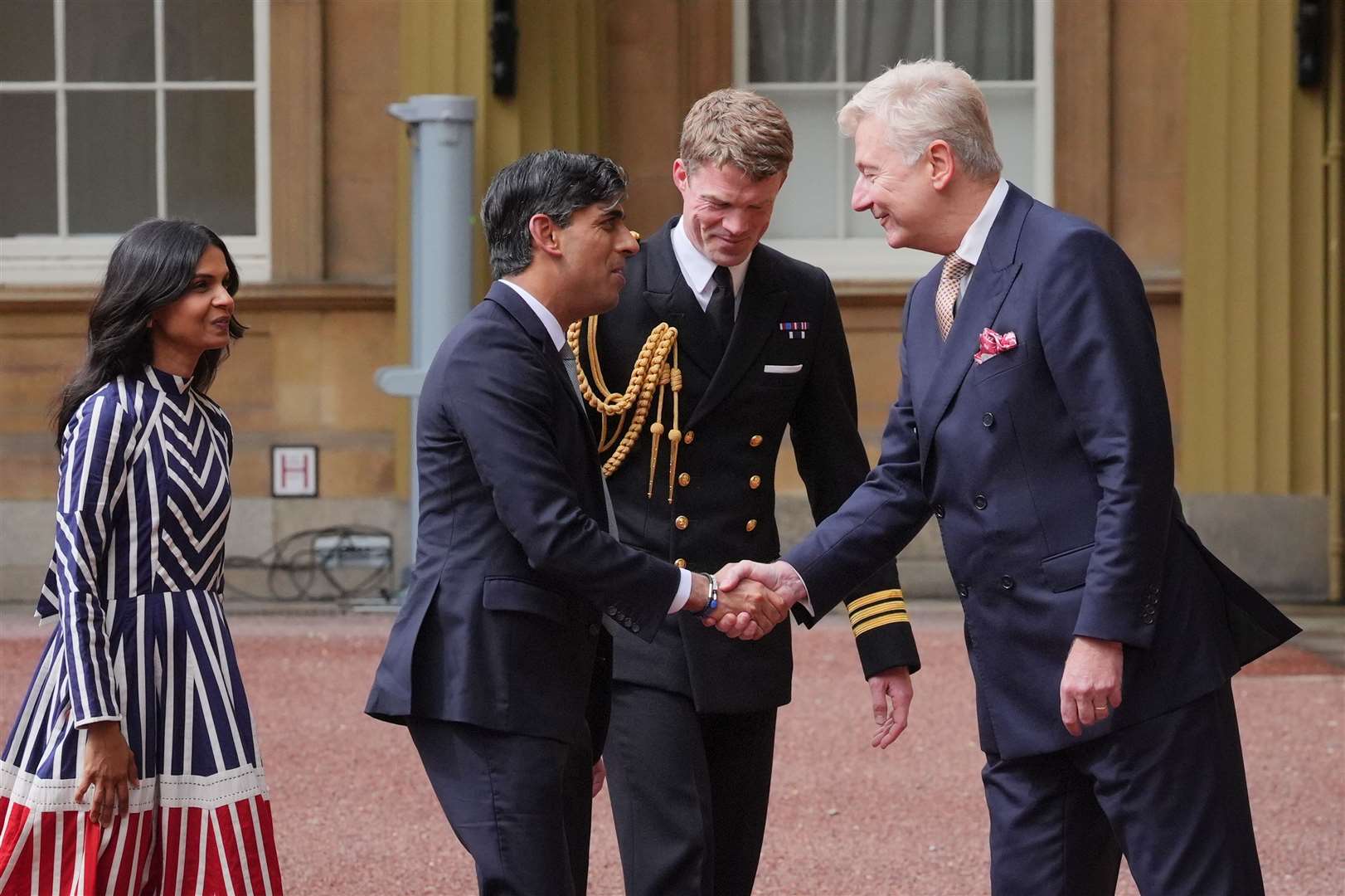 Sir Clive (right) and the King’s equerry, Royal Navy Commander William, Thornton, (2nd right) greet Rishi Sunak and his wife (Jonathan Brady/PA)