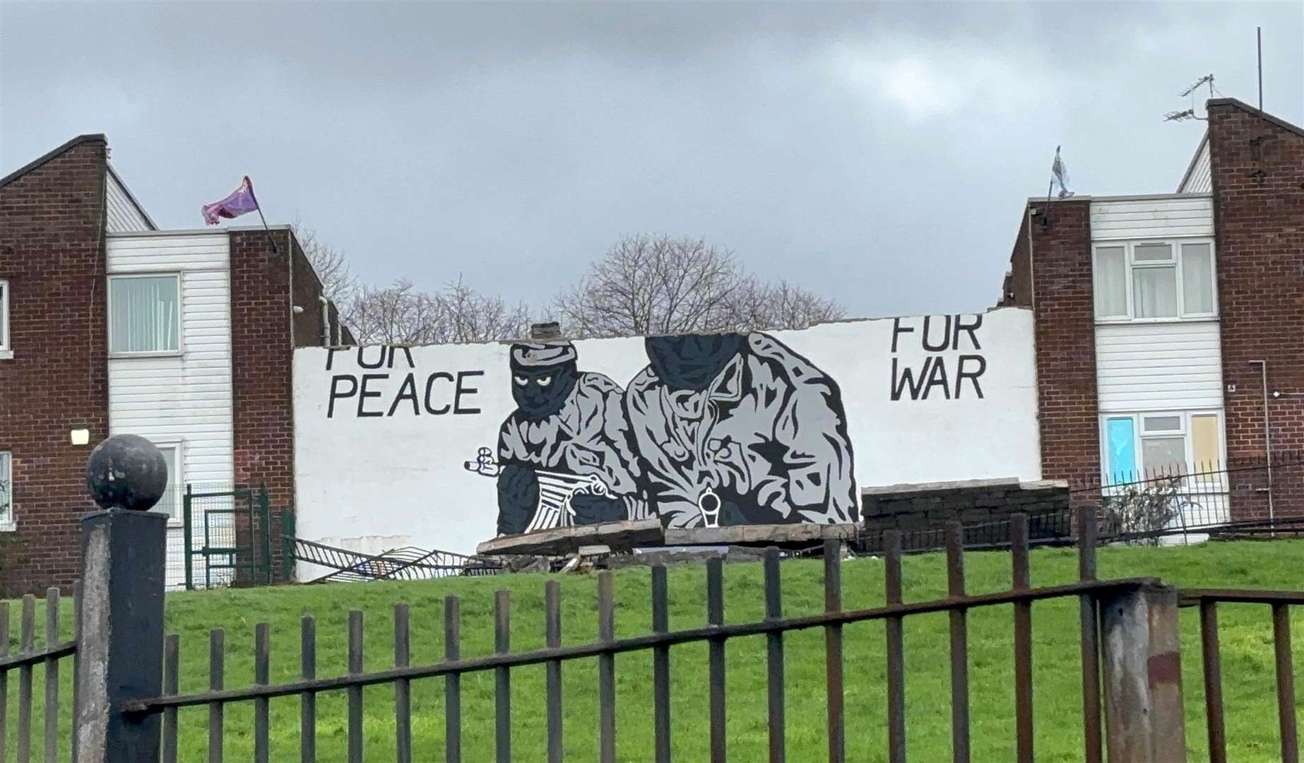 A Northern Ireland loyalist paramilitary mural which previously read ‘Prepared for peace, ready for war’, in the Mount Vernon area of north Belfast on Saturday morning following a night of high winds (PA)