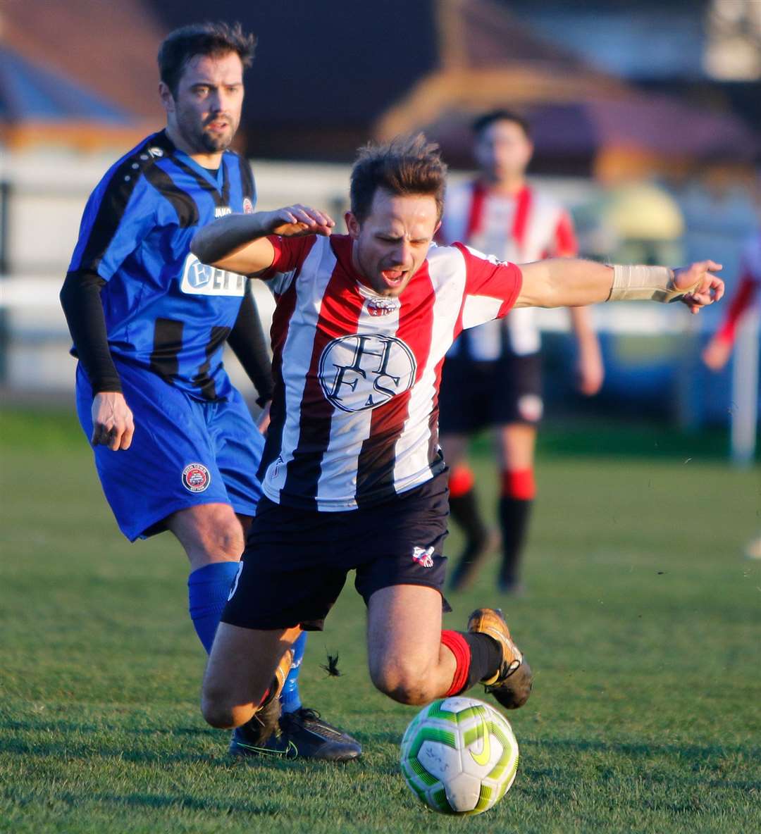 Sheppey's Greg Benbow takes a tumble against Erith Town in last weekend's Kent Senior Trophy clash Picture: Andy Jones