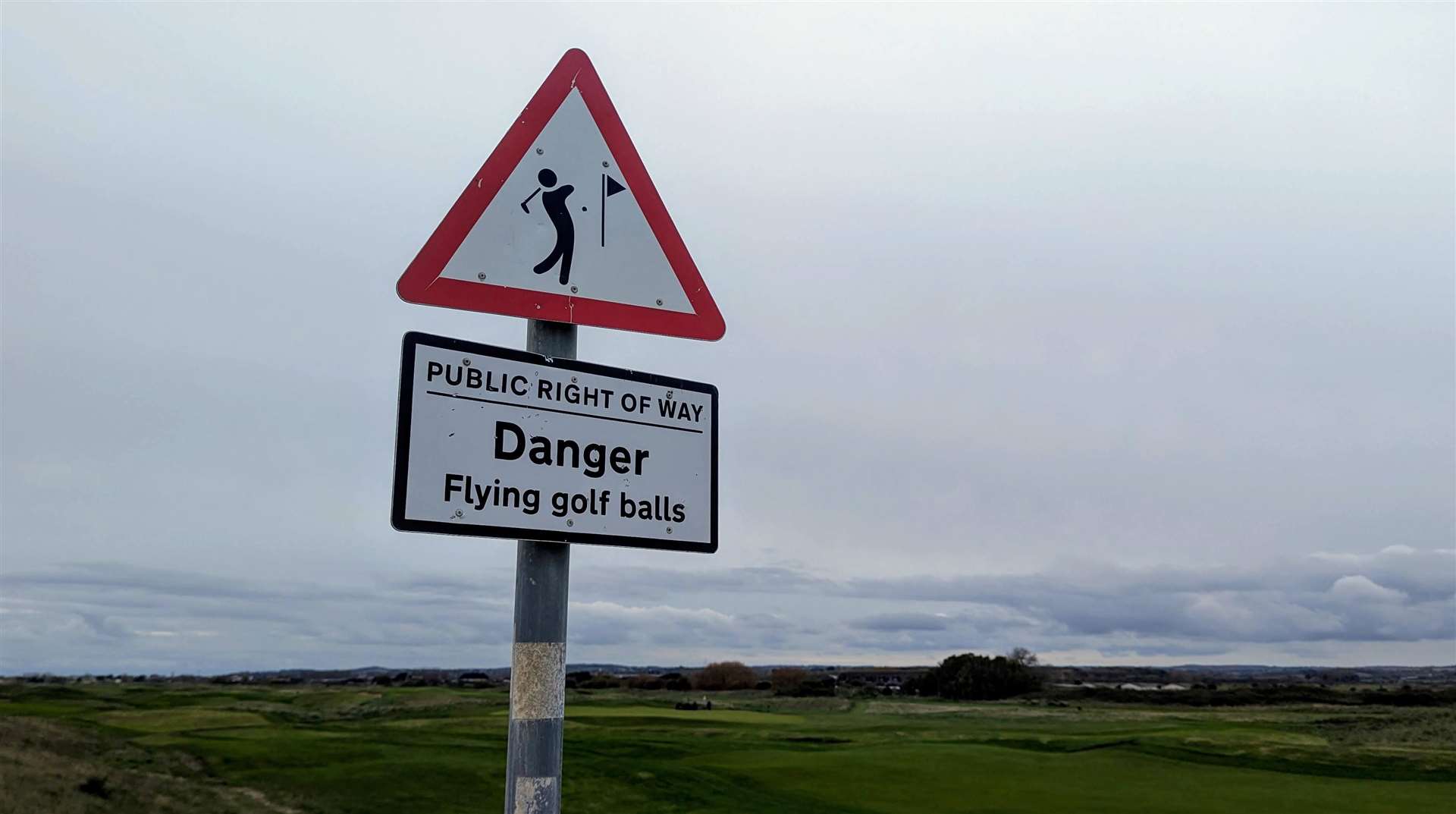 A sign warns of wayward golf balls from the Royal Cinque Ports Golf Club