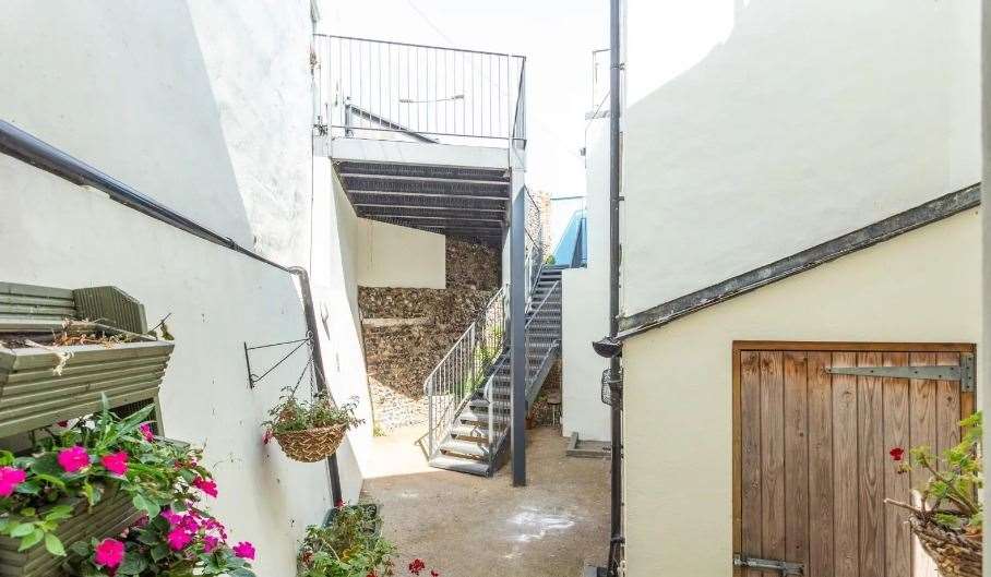 The courtyard leads to a small parking space next to the house. Picture: Miles and Barr