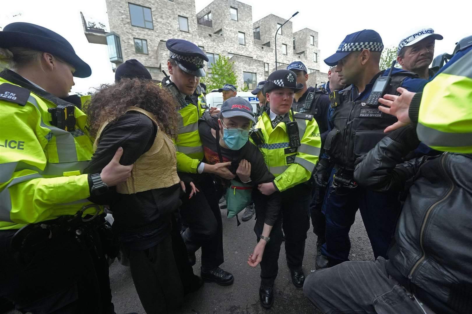 Police remove a protester after demonstrators formed a blockade around the coach (Yui Mok/PA)