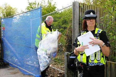 Material is taken away from the spot where the bones were found