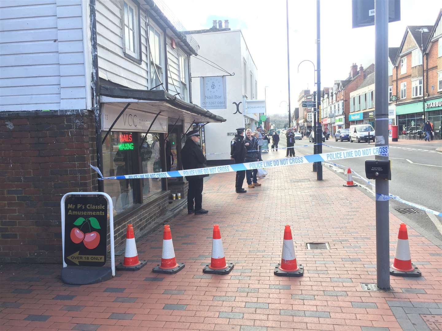 Police outside the nail bar in Tonbridge High Street