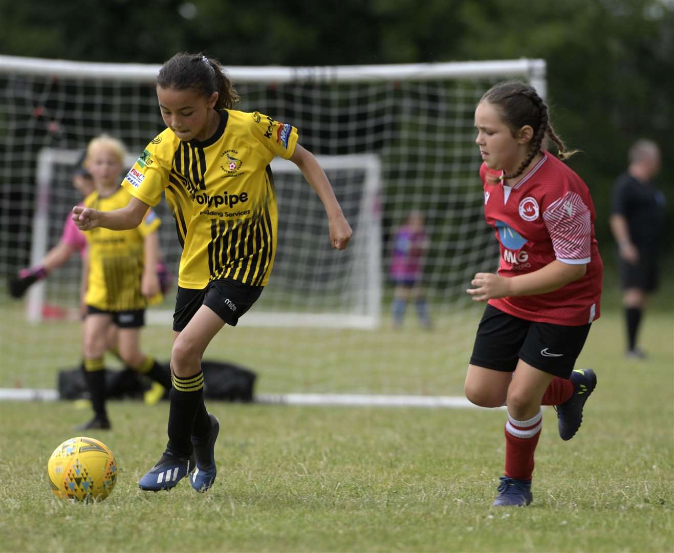 Larkfield under-9s (yellow) in action at their home tournament against Staplehurst Monarchs. Picture: Barry Goodwin