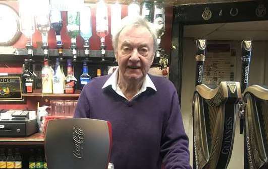 Former landlord Peter Gillard behind the bar