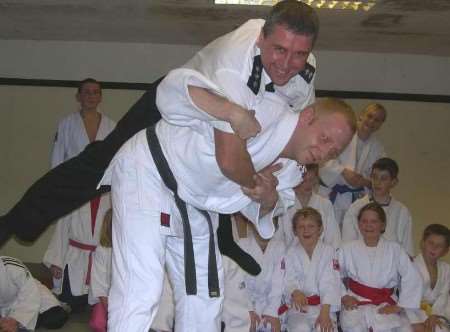 TIGHT GRIP: Chief Insp Peter Wedlake being shown the ropes by instructor Terry Malkinson. Picture: Tessa Hallett