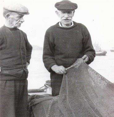 Mending nets. Bill's Grandfather, also Bill, carries out repairs watched by one of his brothers