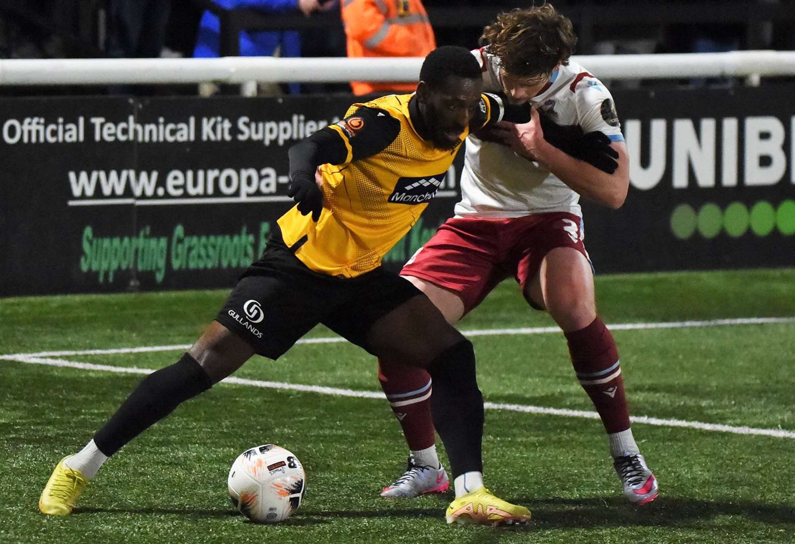 A Stones player holds off a Scunthorpe player. Picture: Steve Terrell