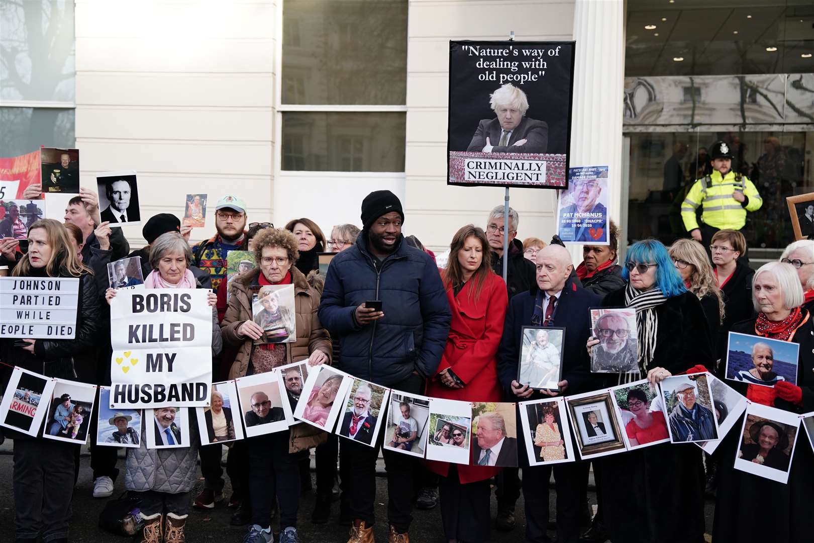 Lobby Akinnola holds a press conference alongside protesters outside the UK Covid-19 Inquiry (PA)